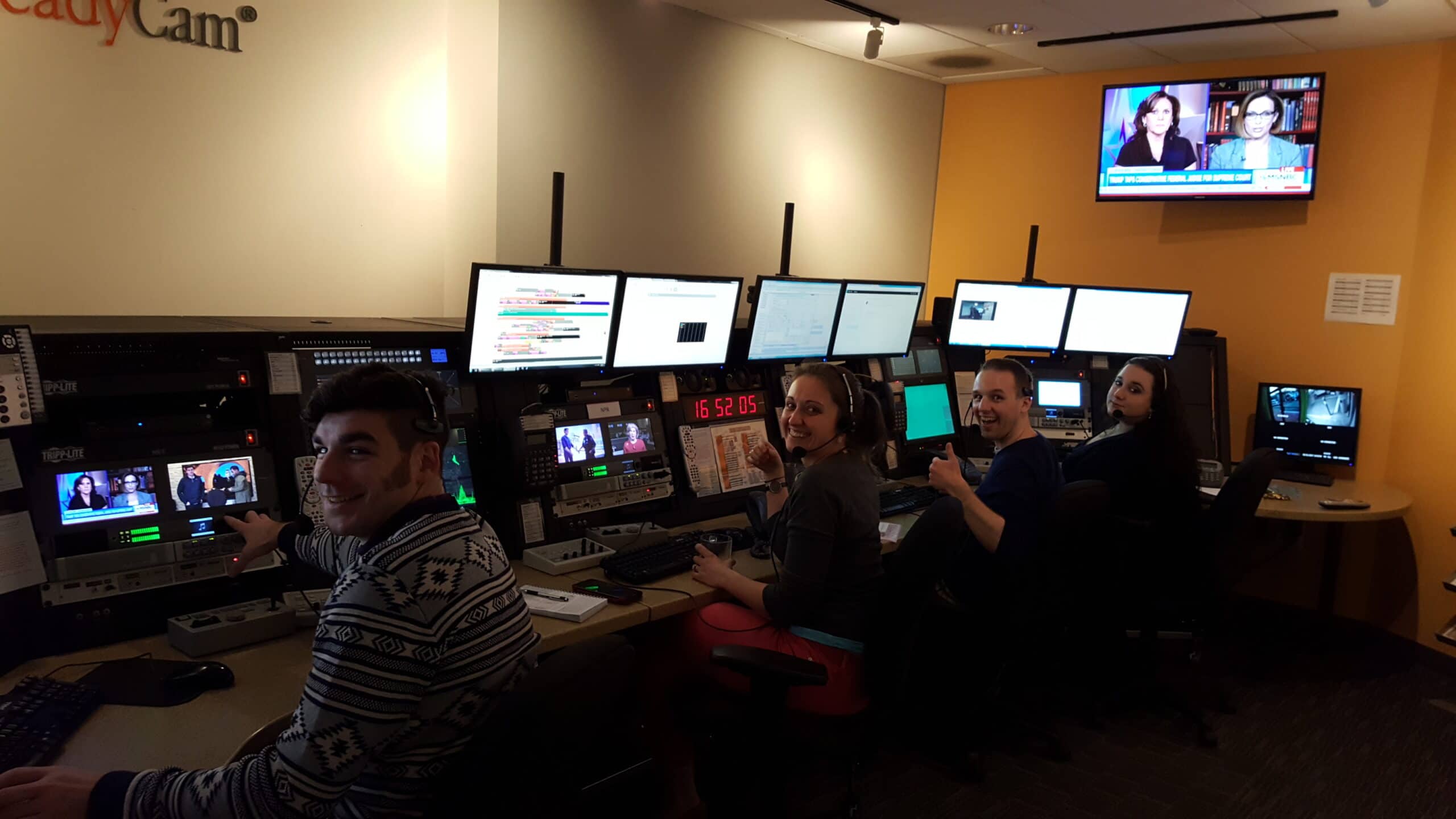 Live broadcast video team at monitors in control room